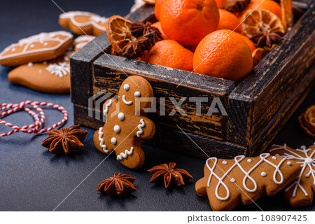 Beautiful festive Christmas composition of tangerines, gingerbread and star anise 108907425