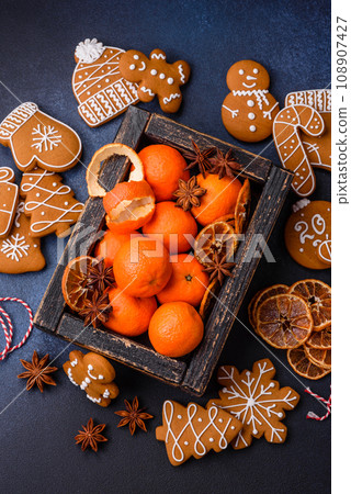 Beautiful festive Christmas composition of tangerines, gingerbread and star anise 108907427