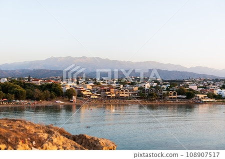 Cityscape at sunset, Agioi Apostoli, Chania, Crete, Greece. 108907517
