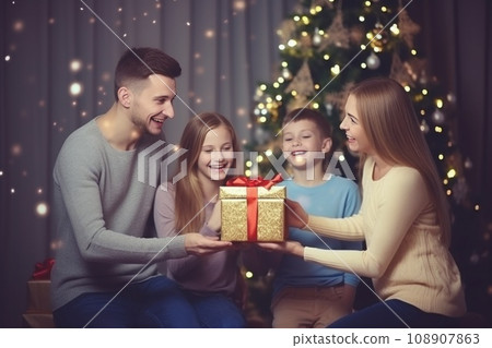 happy family with Merry Christmas magic gift near tree at evening at home 108907863