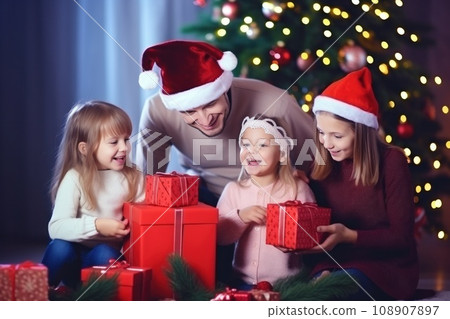 happy family with Merry Christmas magic gift near tree at evening at home 108907897