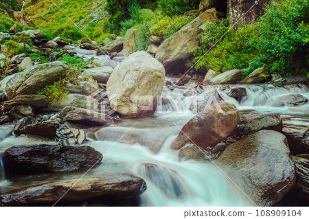 Vintage retro hipster style travel image of cascade of Bhagsu waterfall in Himalayas. Bhagsu, Himachal Pradesh, India. Polarizer filter used 108909104