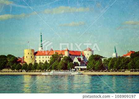Vintage retro hipster style travel image of View of Riga Castle over Daugava river with grunge texture overlaid. Riga, Latvia 108909197
