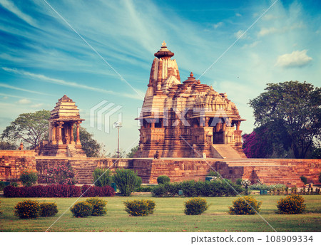 Vintage retro hipster style travel image of Khajuraho Devi Jagdamba temple and mahadev mandapa on sunrise. Khajuraho, India 108909334