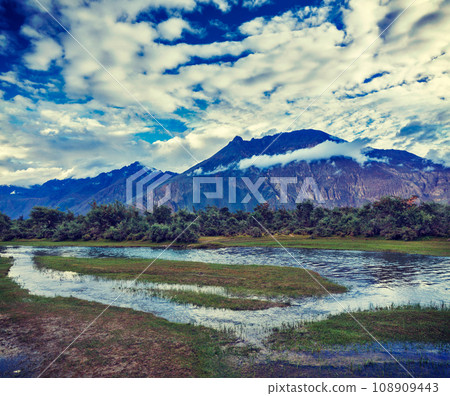 Vintage retro effect filtered hipster style travel image of Panorama of Himalayas and landscape of Nubra valley on sunset. Hunber, Nubra valley, Ladakh, India 108909443