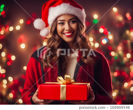 Woman with a Christmas present wearing a hat Woman with a Christmas present wearing a hat 108909546