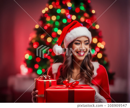 Woman with a Christmas present wearing a hat Woman with a Christmas present wearing a hat 108909547