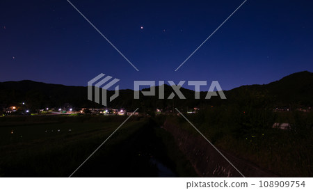 Constellations and planets lined up with the river where fireflies fly 108909754
