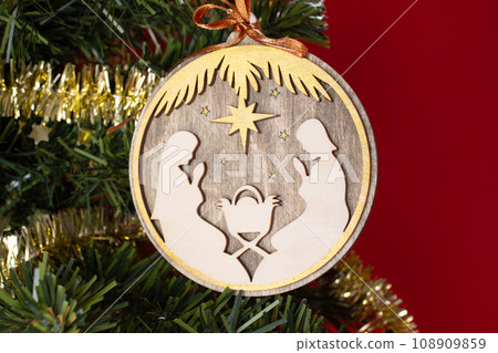 Wooden christmas creche on a wooden background. Christmas tree decoration 108909859