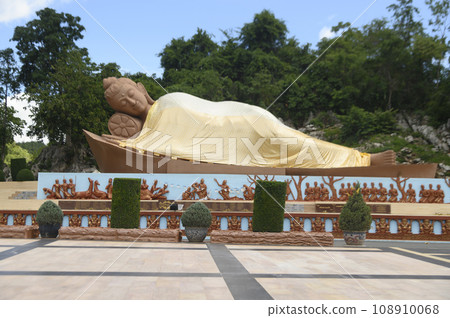 Sandstone reclining Buddha statue The large outdoor at Tham Phu Wa Temple is a Thai art form. It is reddish brown. It has a very beautiful and intricate pattern. Located at Kanchanaburi in Thailand. Sandstone reclining Buddha statue The large outdoor at Tham Phu Wa Temple is a Thai art form. It is reddish brown. It has a very beautiful and intricate pattern. Located at Kanchanaburi in Thailand. 108910068