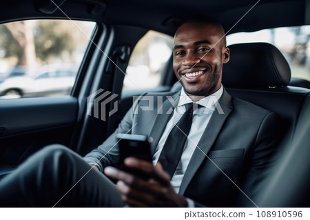 Businessman inside of a car looking at the mobile phone or using mobile phone 108910596