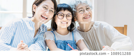 Girl studying and family watching Girl studying and family watching 108911288