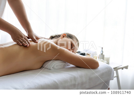 Caucasian woman customer enjoying relaxing anti-stress massage. Quiescent Caucasian woman customer enjoying relaxing anti-stress massage. Quiescent 108911740