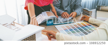 Skilled interior design team carefully selecting curtain materials. Variegated. 108912250