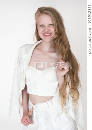 Positive facial expression of blonde woman with closed eyes, laughing toothy smile. Happiness woman 108912581