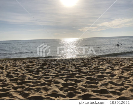 beautiful sunset on the ocean. Vietnam. The sun sets behind the horizon, through the coco, reflected in the water beautiful sunset on the ocean. Vietnam. The sun sets behind the horizon, through the coco, reflected in the water 108912631