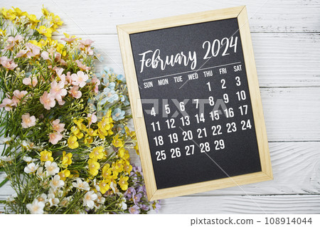 February 2024 monthly calendar with flower bouquet decoration on wooden background February 2024 monthly calendar with flower bouquet decoration on wooden background 108914044