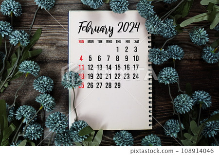 February 2024 monthly calendar with flower bouquet decoration  on wooden background 108914046