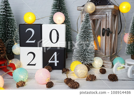 Happy New Year 2024 alphabet letters with Christmas tree decoration on wooden background 108914486