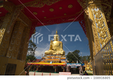 Pra Put Ratanamani Srihathai Naresuan or Luang Por Pan Lan large golden sitting outdoor Buddha in Wat Maniwong. It is a beautiful and faithful Buddha image. Located at Nakhon Nayok in Thailand. Pra Put Ratanamani Srihathai Naresuan or Luang Por Pan Lan large golden sitting outdoor Buddha in Wat Maniwong. It is a beautiful and faithful Buddha image. Located at Nakhon Nayok in Thailand. 108916805