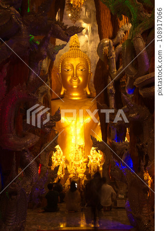 Phra Rattana Mahabadan and the guardian serpent in the Naga cave at Wat Maniwong Temple for Thai people, traveling, praying for blessings, sacred things. Located at Nakhon Nayok Province in Thailand. 108917066