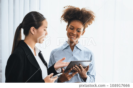 Modern multicultural office worker in corporate workplace wiht tablet. Concord Modern multicultural office worker in corporate workplace wiht tablet. Concord 108917666