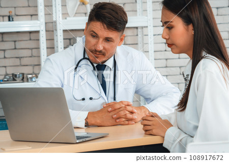 Doctor in professional uniform examining patient at hospital Jivy Doctor in professional uniform examining patient at hospital Jivy 108917672