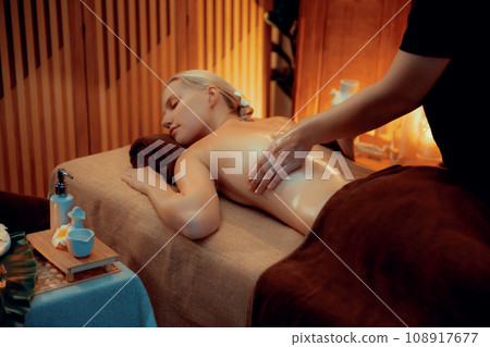 Caucasian woman customer enjoying relaxing anti-stress massage. Quiescent Caucasian woman customer enjoying relaxing anti-stress massage. Quiescent 108917677