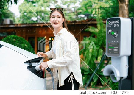 Young woman and sustainable urban commute with EV at cafe. Expedient 108917701
