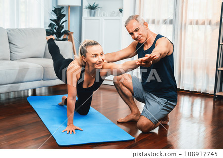 Happy active senior couple in sportswear doing yoga. Clout Happy active senior couple in sportswear doing yoga. Clout 108917745