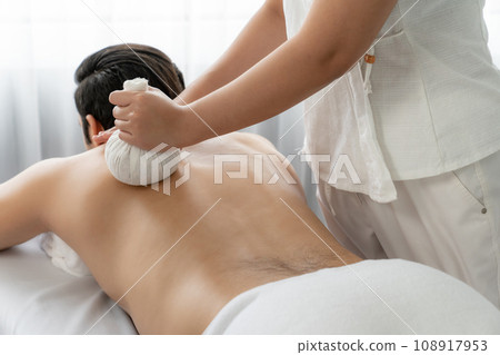 Hot herbal ball spa massage body treatment at day spa . Quiescent Hot herbal ball spa massage body treatment at day spa . Quiescent 108917953