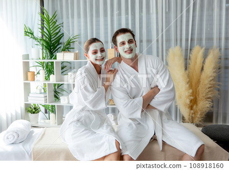 Blissful couple in bathrobe with facial cream mask. Quiescent 108918160