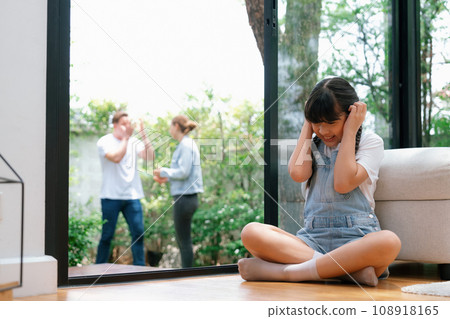 Stressed and unhappy young girl hide from domestic violence at home. Synchronos 108918165