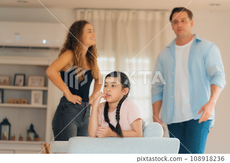 Young girl trapped in the middle of tension by her parent argument. Synchronos Young girl trapped in the middle of tension by her parent argument. Synchronos 108918236