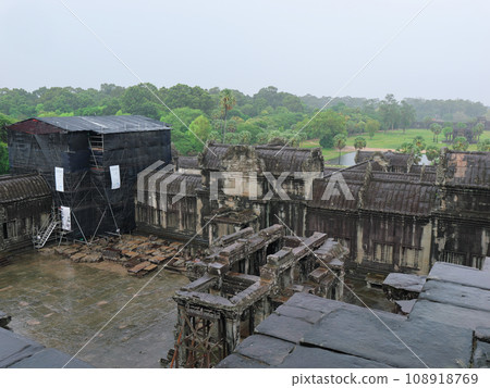 Cambodia, Angkor Wat, view of the central west tower from the third corridor, early morning, cloudy and rainy day Cambodia, Angkor Wat, view of the central west tower from the third corridor, early morning, cloudy and rainy day 108918769