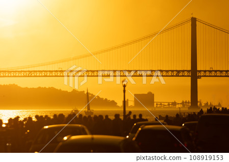 Cars Parked in Front of a Bridge at Sunset 108919153