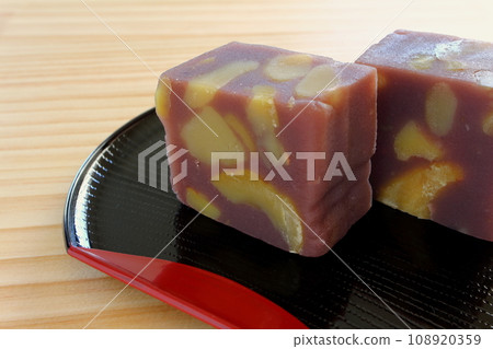 Chestnut steamed yokan served in a half-moon tray on a wooden table 108920359