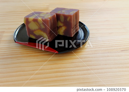 Chestnut steamed yokan served in a half-moon tray on a wooden table 108920370