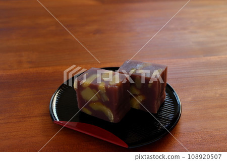 Chestnut steamed yokan served in a half-moon tray on a wooden table 108920507