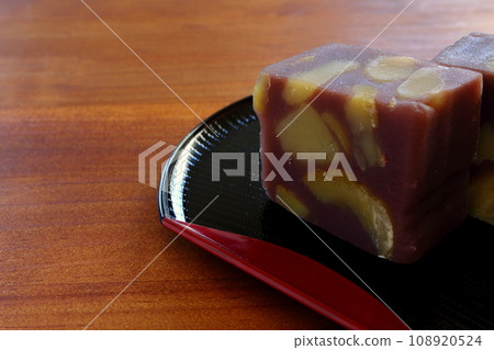 Chestnut steamed yokan served in a half-moon tray on a wooden table 108920524