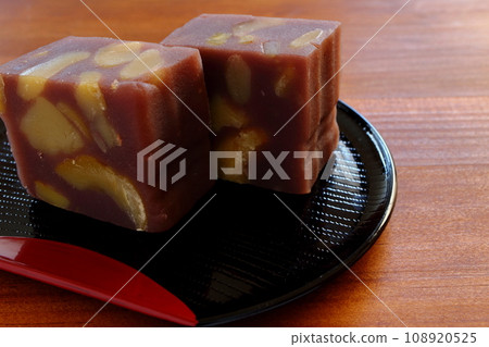 Chestnut steamed yokan served in a half-moon tray on a wooden table 108920525