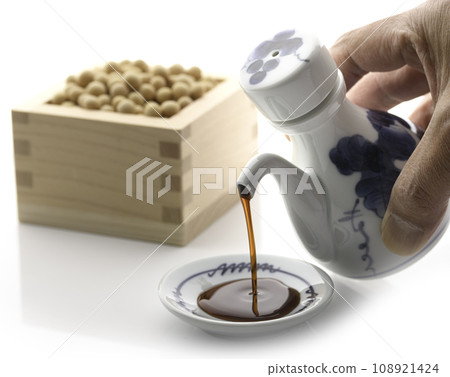 Pour soy sauce into a small plate Pour soy sauce into a small plate 108921424