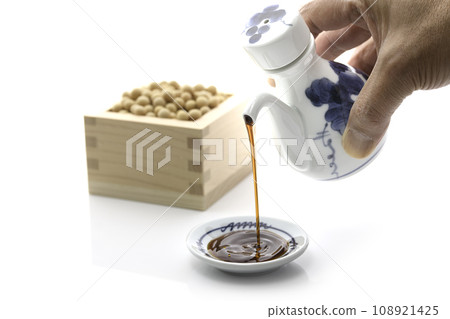 Pour soy sauce into a small plate Pour soy sauce into a small plate 108921425