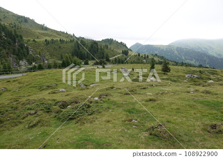 Wide angle landscape view on foggy mountains against a grey sky in the Carpathian alps, Austria Wide angle landscape view on foggy mountains against a grey sky in the Carpathian alps, Austria 108922900