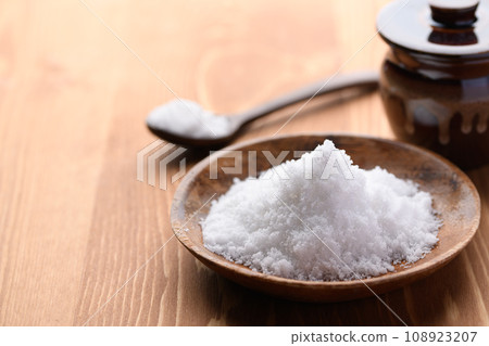 Coarse sea salt made by sun-drying seawater and jars and bottles containing salt. Coarse sea salt made by sun-drying seawater and jars and bottles containing salt. 108923207