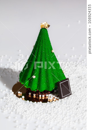 Christmas tree shaped dessert with sugar beads on white Christmas tree shaped dessert with sugar beads on white 108924355