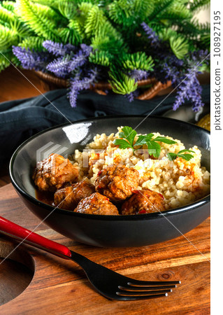 Meatballs pork and mashed potatoein paprika gravy served with groats bulgur. Meatballs pork and mashed potatoein paprika gravy served with groats bulgur. 108927195