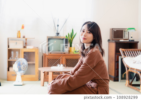 A young woman living in a retro-style room A young woman living in a retro-style room 108928299