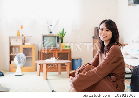 A young woman living in a retro-style room A young woman living in a retro-style room 108928305