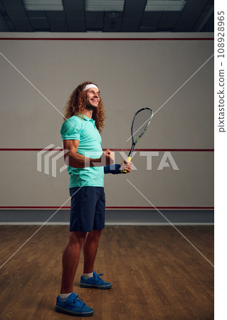 Satisfied squash player clenching fist rejoicing win in game Satisfied squash player clenching fist rejoicing win in game 108928965